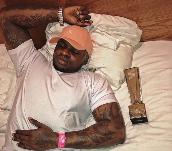 Khaligraph Jones lies alongside the award he won in Nigeria on Saturday, January 11, 2020.